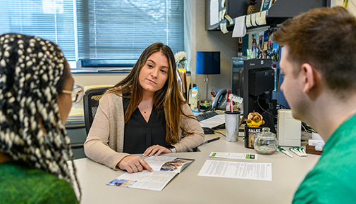 Admissions counselor meeting with two students