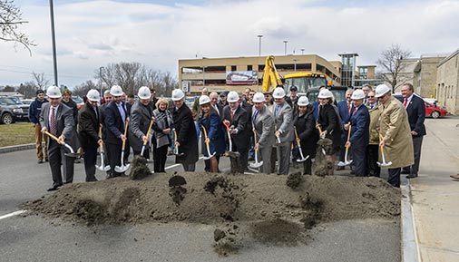 Individuals shoveling dirt