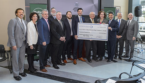 Representatives from Cyprus Creek Renewables presenting a check to Hudson Valley Community College