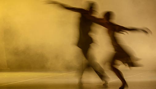Silhouette of two people dancing