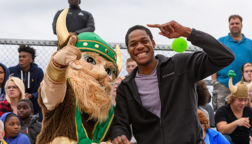 Hudson Valley Community College Viking mascot with a student