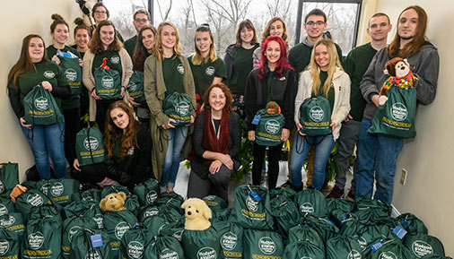 Students pose with filled bags