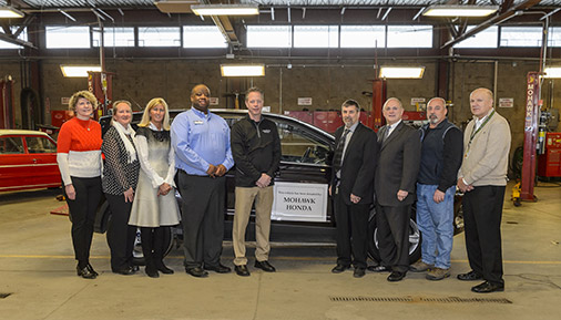 People standing in front of donated vehicle
