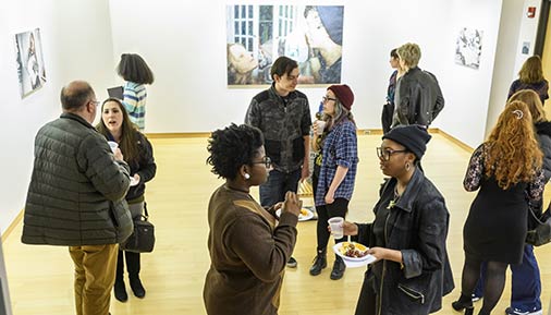 Individuals at an exhibition in the Teaching Gallery