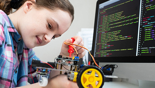 A young girl works on a STEM project
