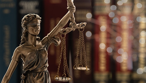 statue of justice or lady justice with law books background.
