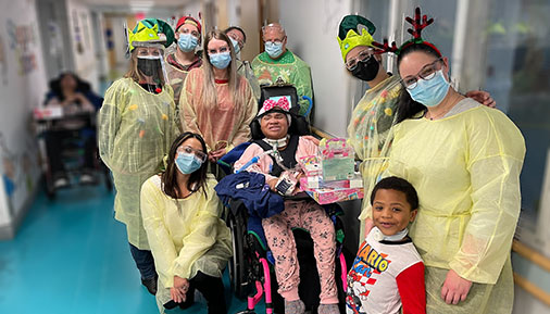 Students bringing gifts to children at Pathways Center