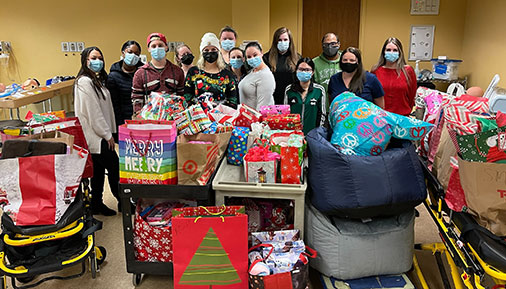 Students pose with gifts purchased for Pathways children