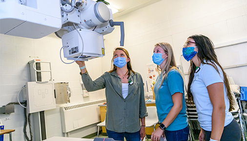 Health science students working an xray machine