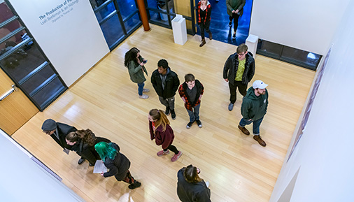 Students looking at artwork in the Teaching Gallery