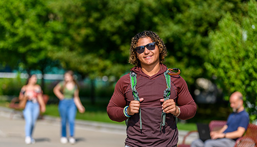 Male student with backpack on campus