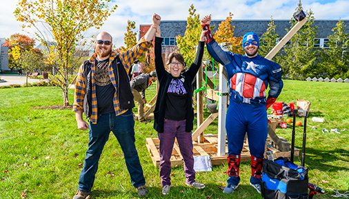 Dr. Lim congratulates the winners of a recent pumpkin toss for engineering design students.