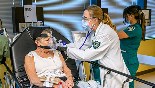 Nursing students work on a patient on a stretcher