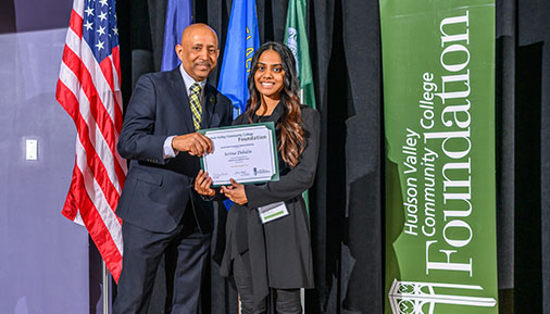 Scholarship recipient with President Ramsammy