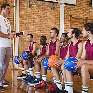 Basketball coach talking to her players