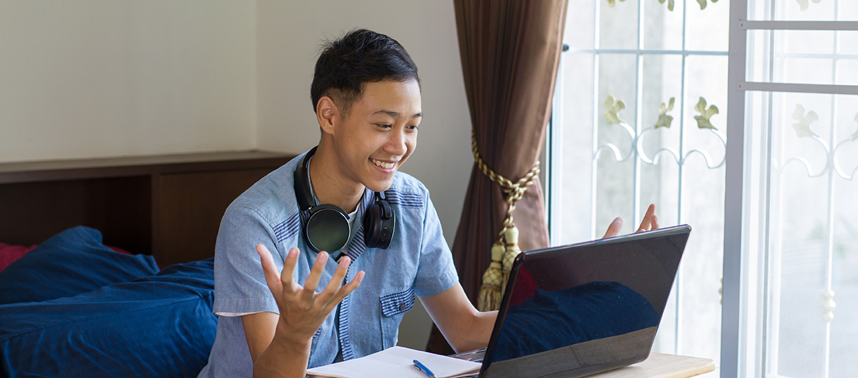 Student with laptop taking online class