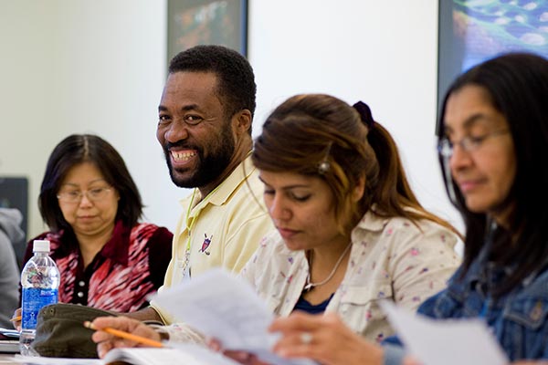 Students working with their teacher in a classroom